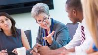A doctor talks with administrative fellows